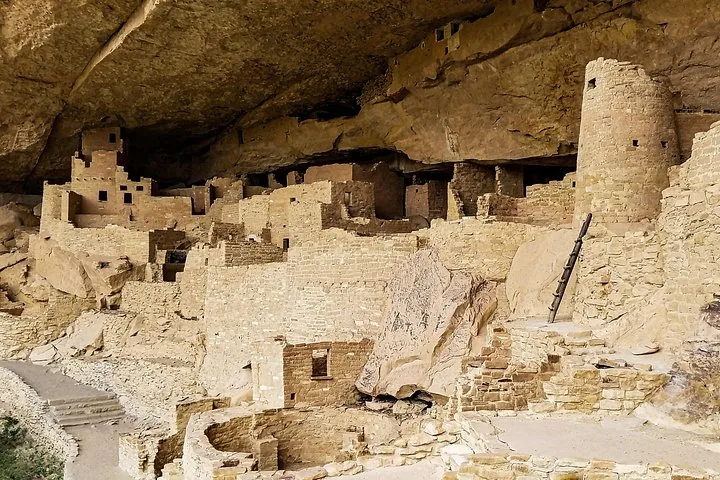 Detailed view of ancient multi-level stone structures built into a cliff.