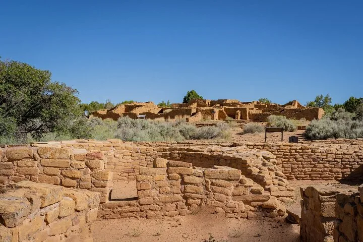 Ruins of ancient stone structures situated on a mesa top.